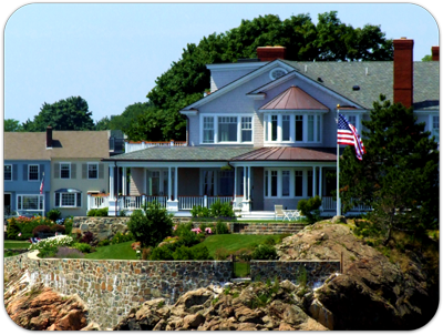 Picture of home with blooming gardens, stone sea wall
